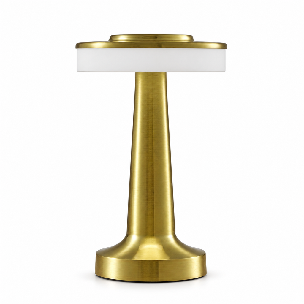 Brushed gold rechargeable touch table lamp switched on in a light interior setting