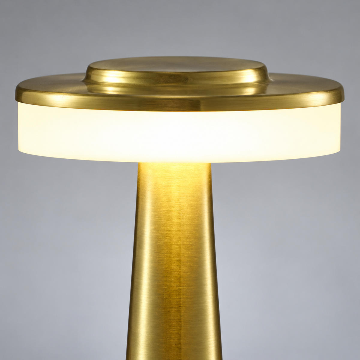 Close-up of the brushed gold lamp finish, touch control and illuminated shade