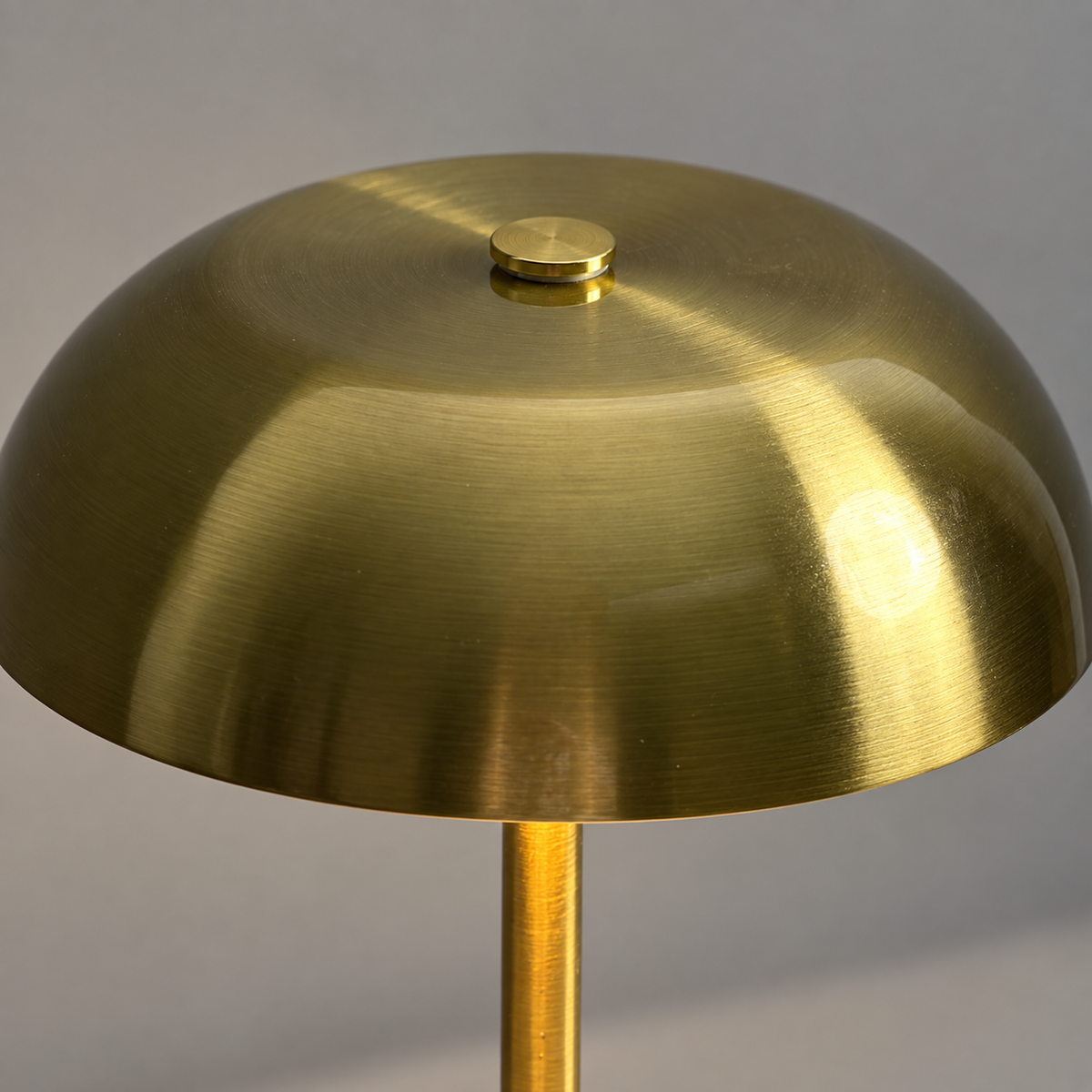Close-up of the brushed gold mushroom shade and top touch control