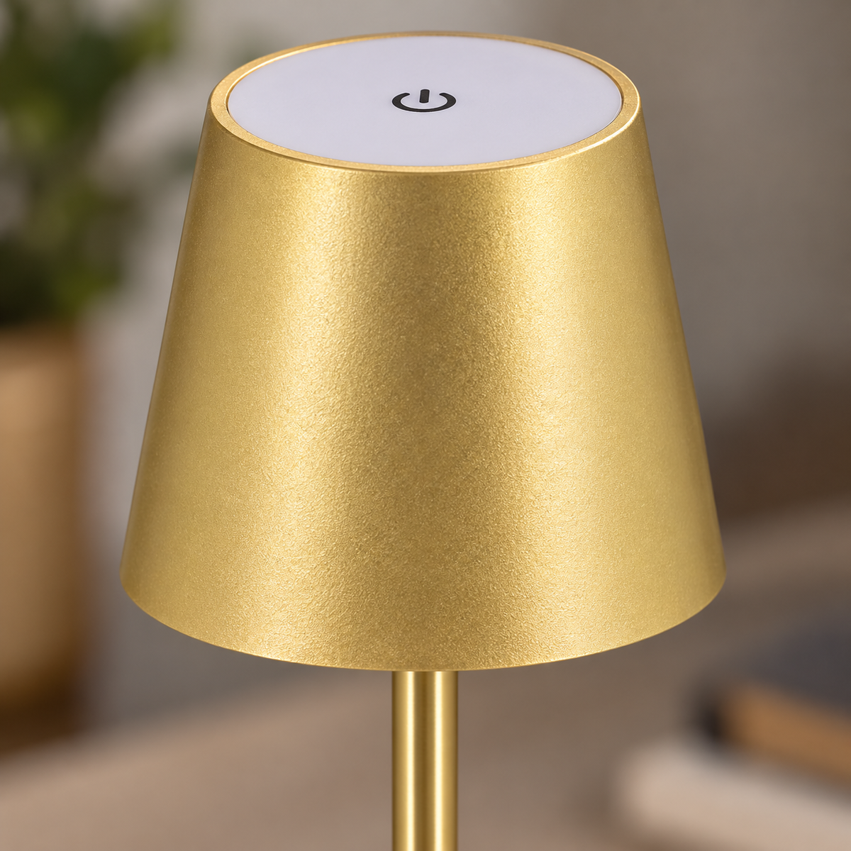 Close-up of the gold lamp shade, touch symbol and twin support rods