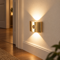 Gold magnetic motion sensor wall light illuminating a warm hallway