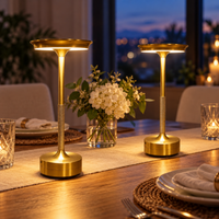 Pair of gold cordless touch lamps on matching bedroom side tables