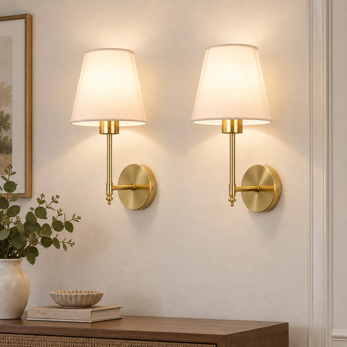Set of two gold rechargeable wall sconces with fabric shades on a light wall
