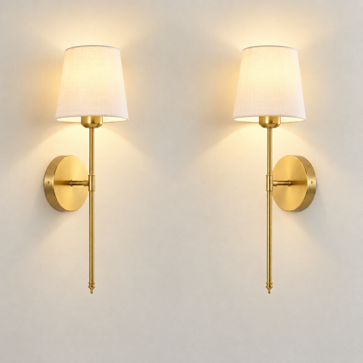 Set of two gold cordless wall sconces with linen shades switched on