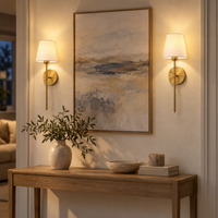 Two rechargeable gold wall sconces lighting a warm living room wall